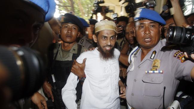 Alleged mastermind of the 2002 Bali bombings Umar Patek escorted by anti-terror police as he arrives at Bali Police Headquarters in Denpasar, Bali, Indonesia 19/10/2011.