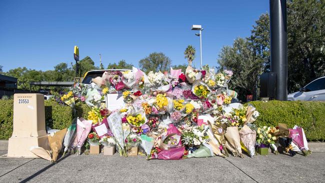 Wreaths of condolence are laid outside McDonalds restaurant in Queen St, Campbelltown where paramedic Steven Tougher died. Picture: NCA NewsWire/Simon Bullard.