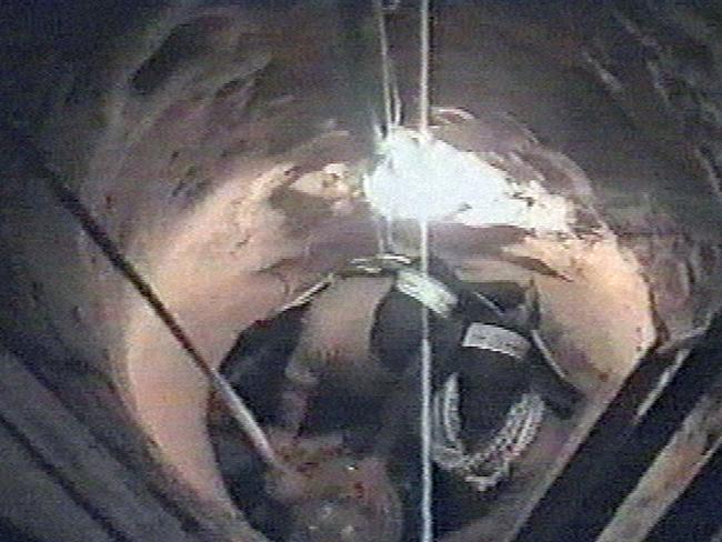 TV grab taken from a video released in 2004 by Hamas showing masked militants gathering objects that were lowered down to them in a tunnel near the Gaza-Egypt crossing.