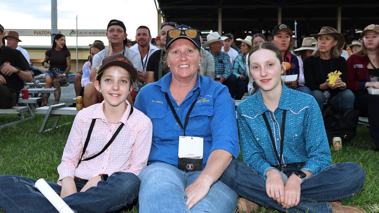 Molly Olley, 10, Tamara Olley and Pippa Olley, 12, attend the 2024 Cairns Bull Throttle event, a bikes and bulls show, featuring bull riding and freestyle motorcross ridiers. Picture: Brendan Radke