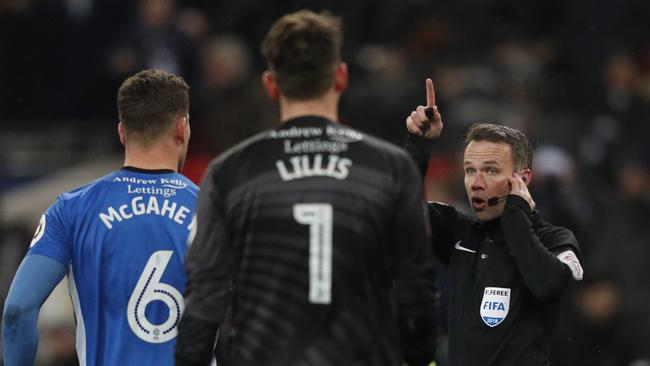 Referee Paul Tierney listens to a VAR decision on Tottenham Hotspur's Argentinian midfielder Erik Lamela's goal which is disallowed during the English FA Cup 5th round replay football match between Tottenham Hotspur and Rochdale at Wembley Stadium in February. Picture: AFP 