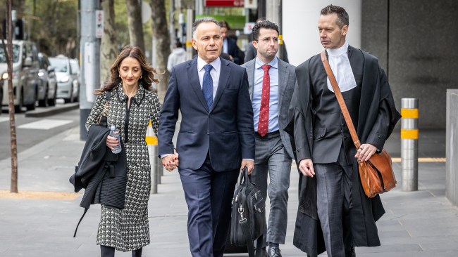 Victorian Opposition Leader John Pesutto arrives at court alongside his wife and barrister Dr Matthew Collins KC. Picture: Jake Nowakowski / NCA