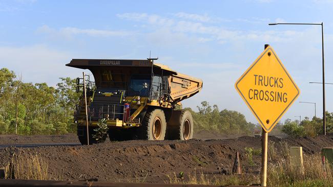 A haul truck drives past a crossing at South32's GEMCO manganese mining operation on Groote Eylandt.