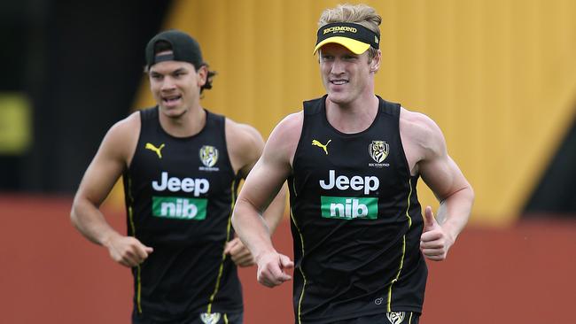 Josh Caddy, right, runs with Daniel Rioli at Richmond pre-season training.