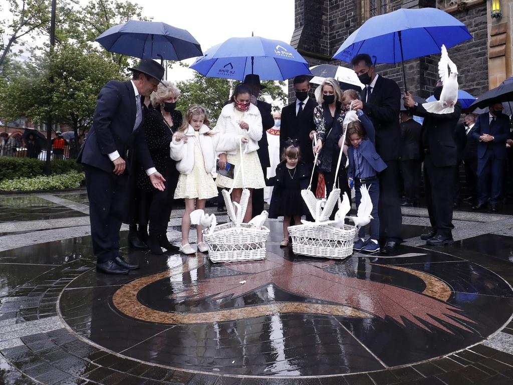 The family were arm-in-arm, while white doves were released into the sky. Picture: Darrian Traynor/Getty Images