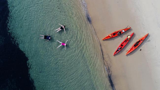 SUNDAY TELEGRAPH - MUST NOT USE UNLESS CLEARED WITH JEFF DARMANIN  - Aerial images above the Northern Beaches showing crystal clear waters. Cabbage Tree Bay on the harbour side of Manly beach shown. Ben Croston with daughter Ashleigh Nagle and her mother Joanne Nagle floating after a kayak on the water.