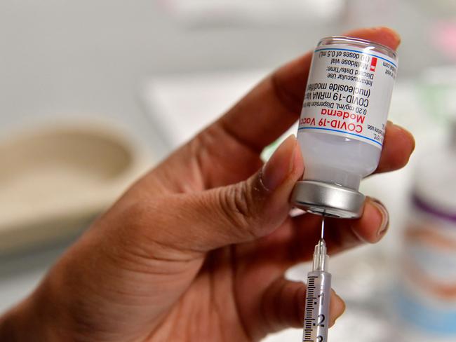 Health worker prepares a dose of Moderna Covid-19 booster vaccine at the Toulouse's exhibition centre used as a vaccination centre in Toulouse, on December 9, 2021. - After several weeks of closure, the vaccination centre is back in service on December 9, 2021. (Photo by GEORGES GOBET / AFP)