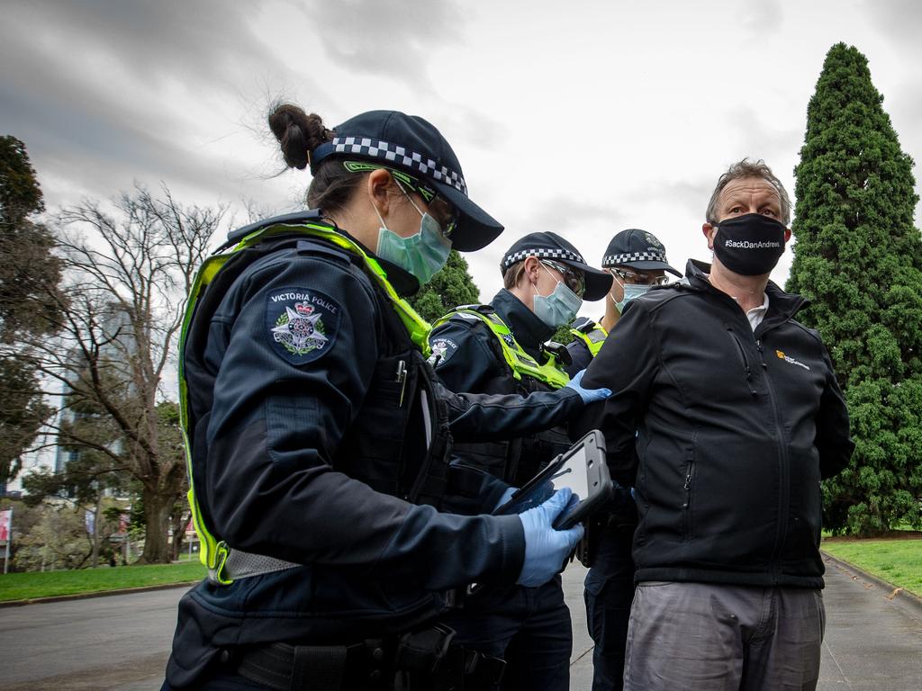 A man is detained by police during an anti-lockdown rally in Melbourne. Picture: Darrian Traynor/Getty Images