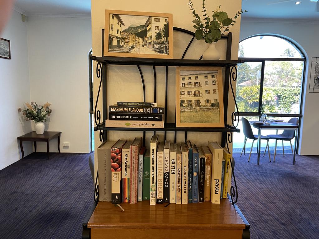 Mark has decorated the restaurant centrepiece with his own cookbooks and paintings of his grandmothers village in Northern Italy. Photo: Fergus Gregg