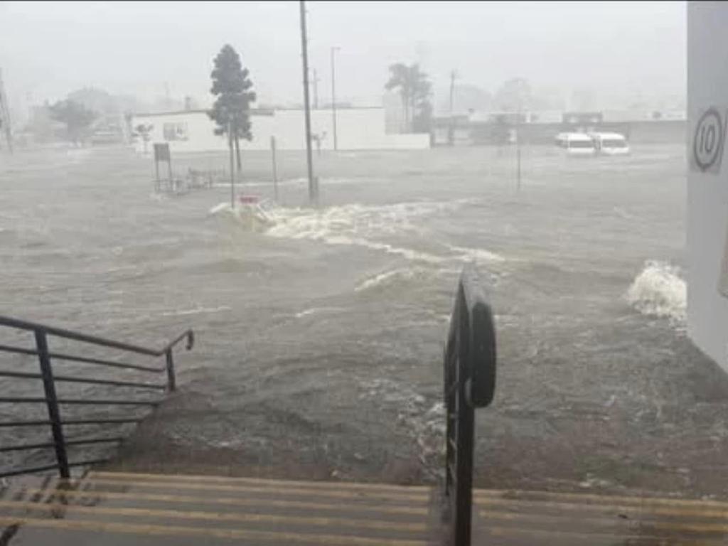 Flash flooding rockets through the carpark of Pialba Central to the RSL at Pialba in Hervey Bay during the wild weather brought by ex-Tropical Cyclone Alfred.