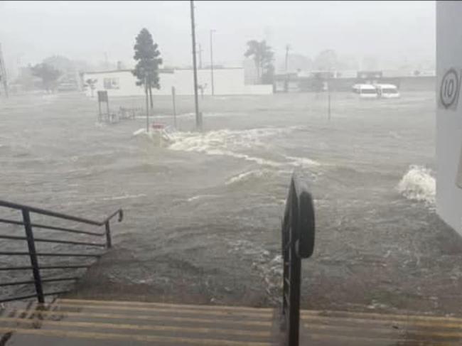 Flash flooding rockets through the carpark of Pialba Central to the RSL at Pialba in Hervey Bay during the wild weather brought by ex-Tropical Cyclone Alfred.