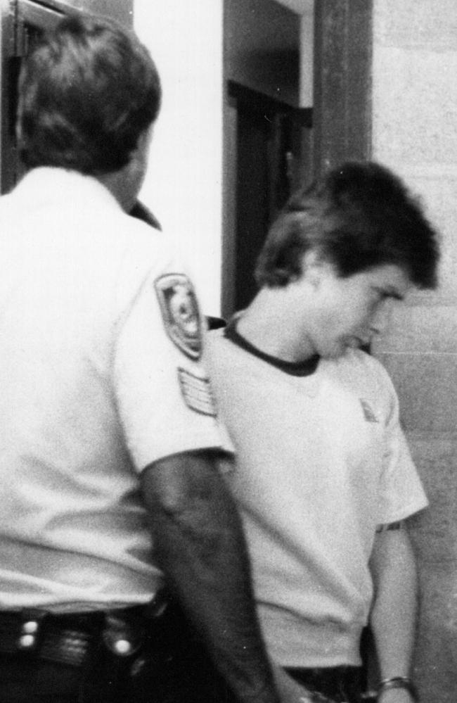 John Travers being led away by police after the brutal murder of Anita Cobby in 1986. Picture: AAP