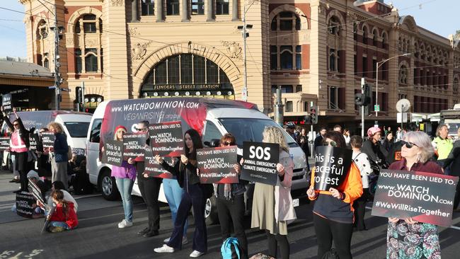 Animal rights protesters block the intersection of Flinders and Swanston Street, Melbourne disrupting early morning traffic in April, 2019.