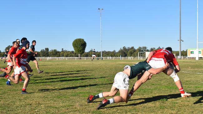 Spectators cheer on as they watch the B Grade St George vs Condamine match at the Roma Rugby Races at Bassett Park. Picture: Chloe Cufflin.