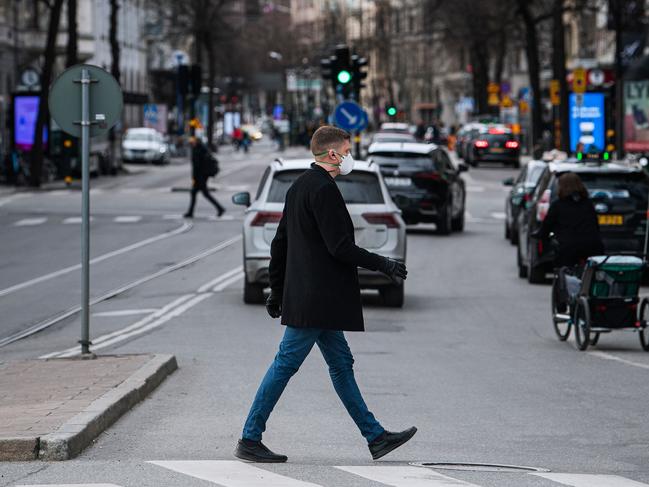 A man crossing the road during the coronavirus pandemic. Sweden’s parliament passed a new law granting the government temporary powers to quickly adopt measures aimed at curbing the spread of the new coronavirus without prior parliamentary approval. Picture: Jonathan Nackstrand/AFP