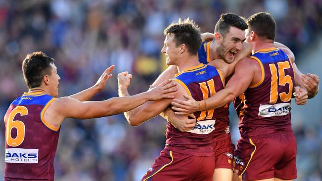 Lincoln McCarthy is mobbed after kicking a late winner against his former club Geelong. Picture: AAP Image/Darren England.