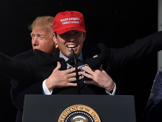 Baseball player Kurt Suzuki wears a "Make America Great Again" hat as US President Donald Trump and First Lady Melania Trump welcome the 2019 World Series Champions, The Washington Nationals, to the White House on November 4, 2019 in Washington,DC. (Photo by Olivier Douliery / AFP)