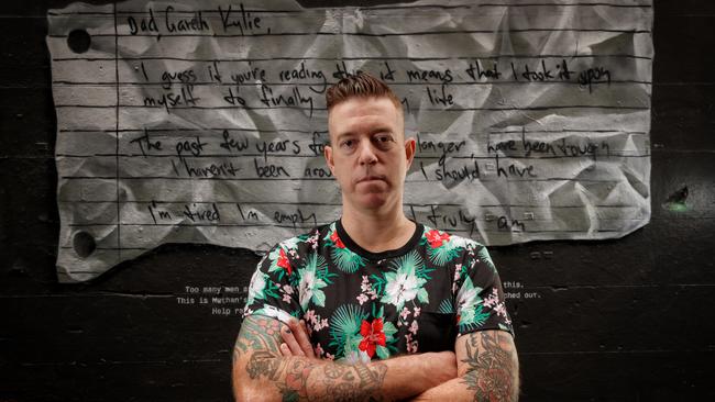 Mo Bro and mental health advocate Nathan Tomlin in front of his suicide note artwork in Hosier Lane. Note: The artwork was developed in consultation with the mental health and suicide prevention sector. Picture: AAP