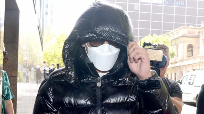 The 21-year-old covered his face with a mask, glasses and $2,000 Moncler puffer as he left court. Picture: NCA NewsWire / Andrew Henshaw