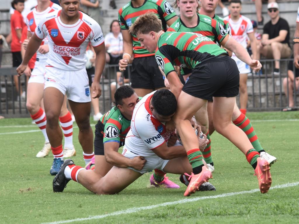 Alex Futialo fights through the tackle of Daniel Lua (left) and Cody Hill. Picture: Sean Teuma