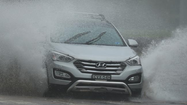 Water is blown over a car on Surfview Rd, Mona Vale. Picture: John Grainger