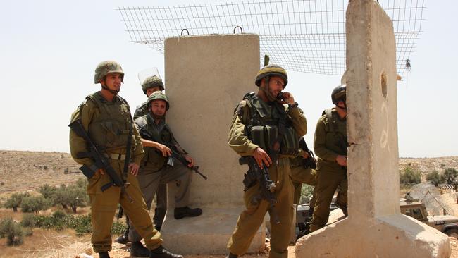 Israeli Defence Force soldiers prepare for the arrival of Palestinian protesters in Ni'lin, west of Ramallah. (Pic: Supplied)