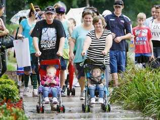 Daughters of deceased mother Alexis Crawley – Zoe Crawley (left), 2, and Elizabeth Crawley, 3, – with their father Troy Johnson and grandmother Janice Johnson on a fundraising walk with supporters and event organiser Kelly Boxell (centre). Picture: David Nielsen