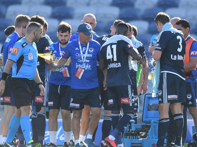 5.30PM: Melbourne Victory players take a break against Central Coast Mariners during due to the heat. Picture: AAP