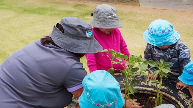 Children having some outdoor fun with a childcare educator at Goodstart Early Learning Centre