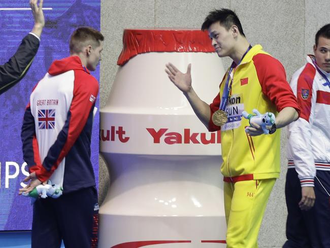 Gold medallist China's Sun Yang, centre, gestures to Britain's bronze medallist Duncan Scott, left, following the medal ceremony in the men's 200m freestyle final. Picture: AP Photo/Mark Schiefelbein