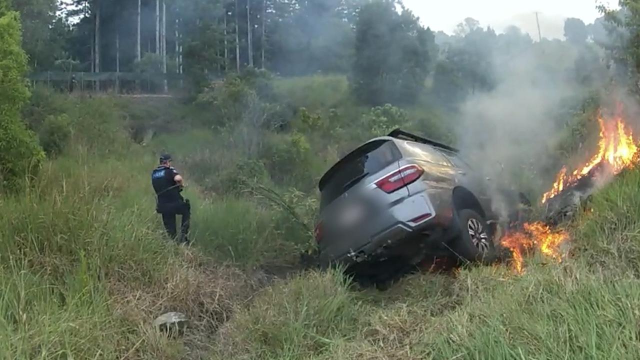 The car was allegedly crashed which started a grass fire. Picture: QPS