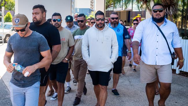 Police officer Daniel Mark Keelan (centre) leaves the Darwin Local Court on bail surrounded by friends and family after being charged with drug offences.