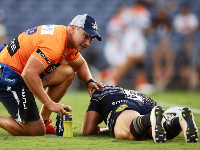 Antonio Winterstein of the Cowboys is checked by medical staff before leaving the field.