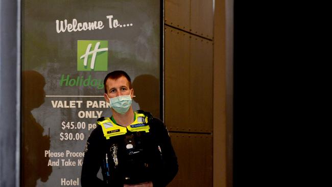 Police outside the Holiday Inn on Flinders Lane. Picture: NCA NewsWire / Andrew Henshaw