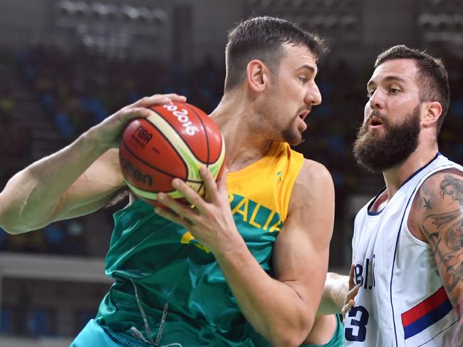 Australia's centre Andrew Bogut (L) holds on to the ball next to Serbia's centre Miroslav Raduljica during a Men's round Group A basketball match between Serbia and Australia at the Carioca Arena 1 in Rio de Janeiro on August 8, 2016 during the Rio 2016 Olympic Games. / AFP PHOTO / Andrej ISAKOVIC