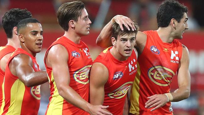 Gold Coast players celebrate a goal against Geelong. Picture: Getty Images