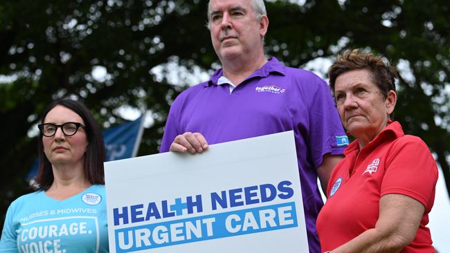 Kate Veach, Dr Sandy Donald and Trish Berrill lead a rally outside Cairns Hospital. Picture: Emily Barker