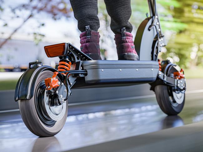 Electric scooter fast ride through the city - closeup to back wheel, motion blur effect. Picture: istock