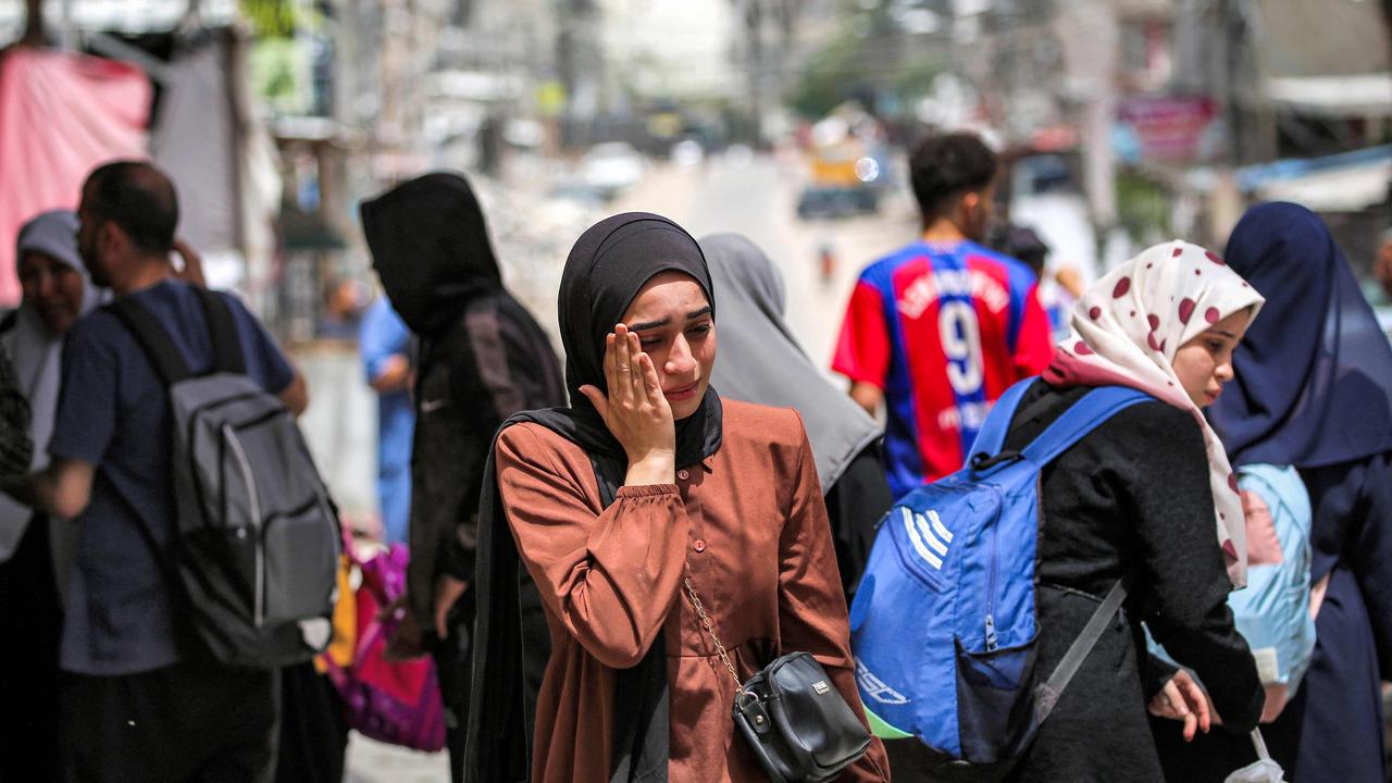 A woman reacts as she wait with others before evacuating from Rafah in the southern Gaza Strip on May 11, 2024 amid the ongoing conflict in the Palestinian territory between Israel and Hamas. (Photo by AFP)