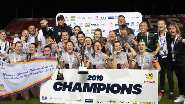 Adelaide City players and officials celebrate their treble after beating West Adelaide in the Women's National Premier League Football grand final. Picture: AAP/Emma Brasier