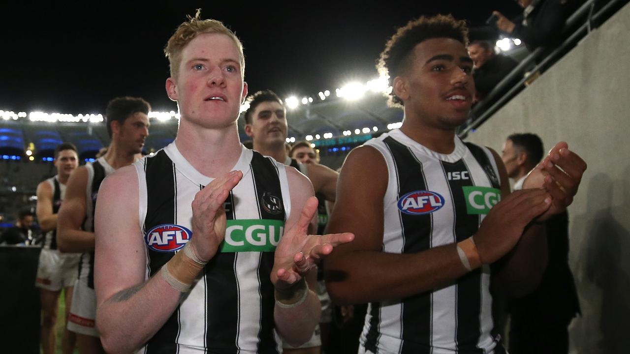 PERTH, AUSTRALIA - JULY 12: John Noble and Isaac Quaynor of the Magpies lead the team into the rooms after winning the round 17 AFL match between the West Coast Eagles and the Collingwood Magpies at Optus Stadium on July 12, 2019 in Perth, Australia. (Photo by Paul Kane/Getty Images)