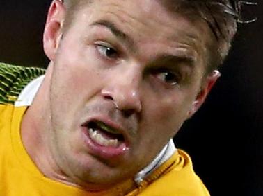 LONDON, ENGLAND - OCTOBER 25: Drew Mitchell of Australia breaks the challenge of Lucas Gonzalez Amorosino of Argentina on the way to setting up Adam Ashley-Cooper (not pictured) to score Australia's 4th try of the game during the 2015 Rugby World Cup Semi Final match between Argentina and Australia at Twickenham Stadium on October 25, 2015 in London, United Kingdom. (Photo by Michael Steele/Getty Images)