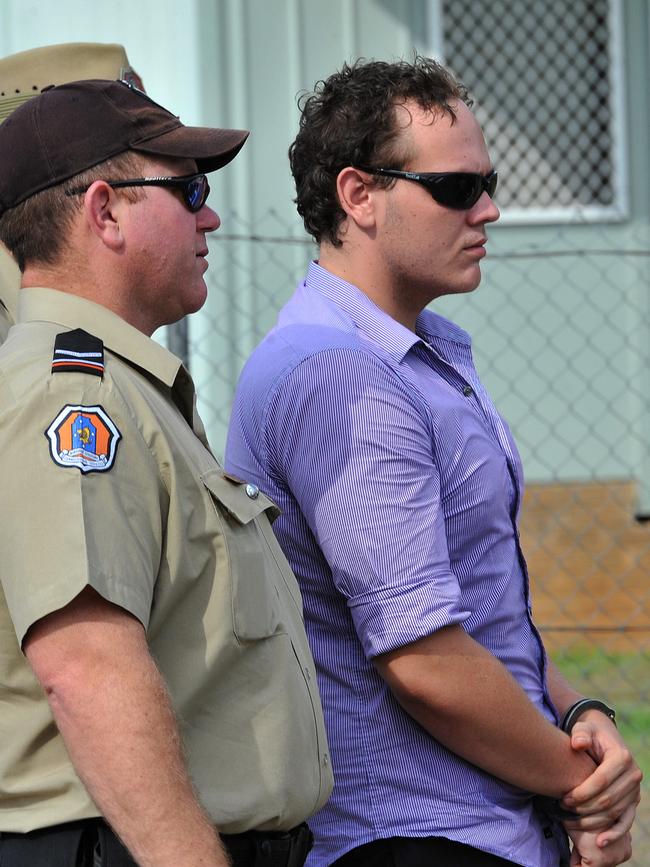 Zak Grieve, flanked by NT Police officers and guards,  visits the crime scene where Ray Niceforo was murdered