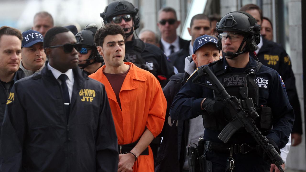 Luigi Mangione arrives at a heliport with members of the NYPD. Picture: Spencer Platt/Getty Images/AFP