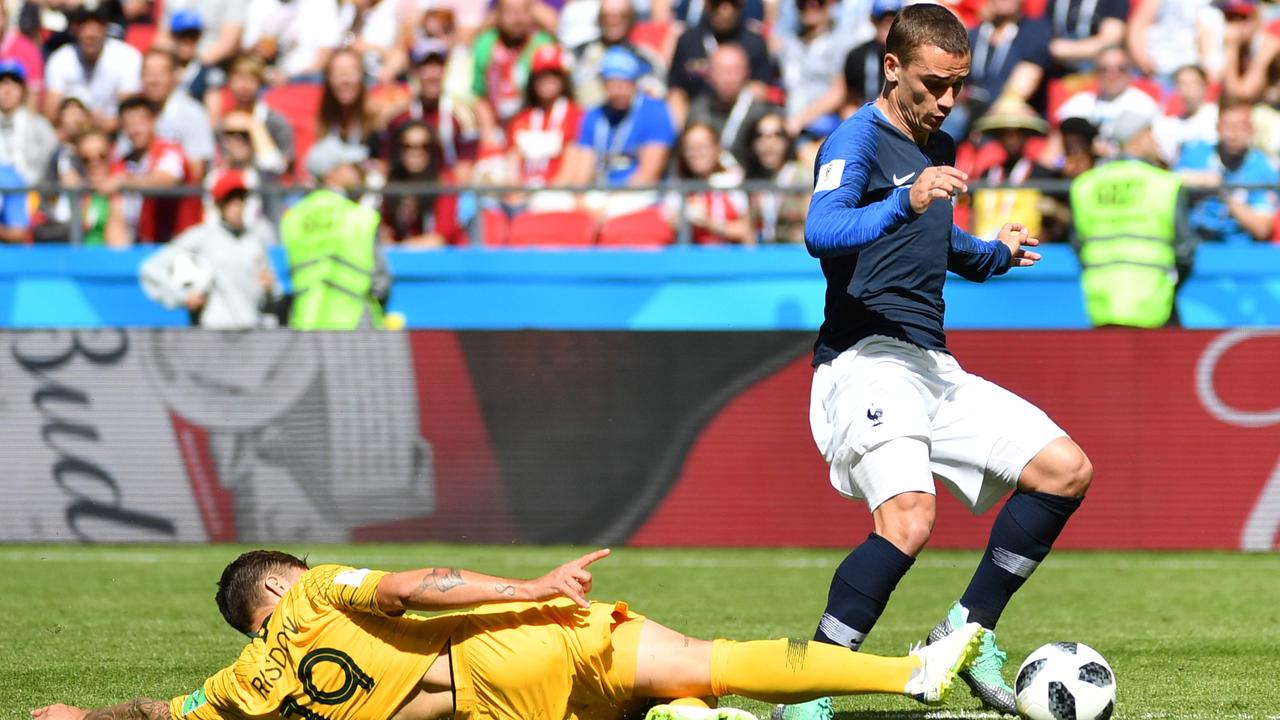 France's forward Antoine Griezmann is tackled by Australia's defender Joshua Risdon.