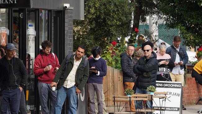 People are seen queuing outside a Centrelink office in Brunswick, Melbourne.