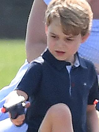 Prince George appeared to be having fun with the toy gun. Picture: Mega.