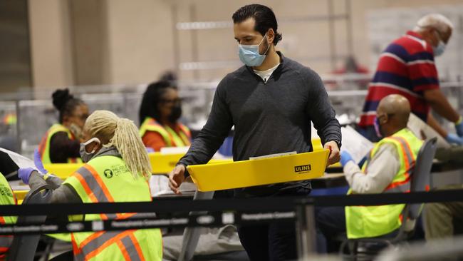 Election workers count ballots in Philadelphia, Pennsylvania last night.