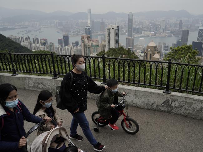 Tourists wear masks at the Peak, a popular tourist spot in Hong Kong. Picture: AP