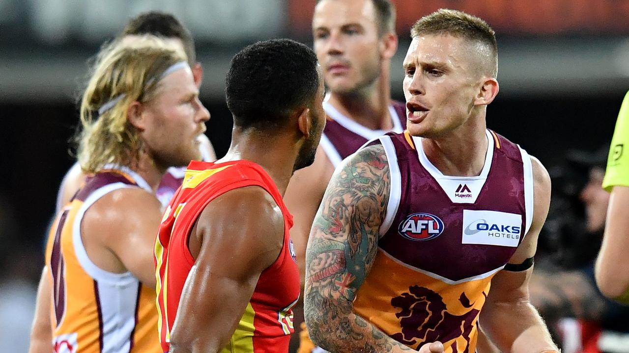 Dayne Beams engages Gold Coast midfielder Touk Miller in a game this year.